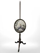 An early 20th century mahogany needlework pole screen,