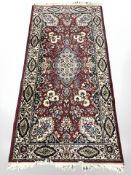 A machine made rug of Persian design,