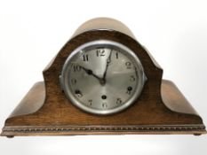 An early 20th century oak Napoleon hat mantel clock,