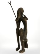 An African cast metal figure of an elder with staff, height 22 cm.