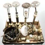 A group of brass lamp bases with continental plugs, EPNS candlesticks and other metal wares.