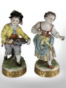 A pair of 20th century German porcelain figurines in the style of Meissen,