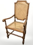 A cane open armchair.