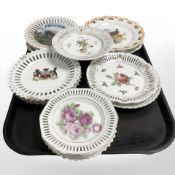 Sixteen various pierced rim porcelain plates.
