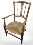 An Edwardian beech and rattan farmhouse armchair