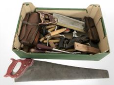 A group of vintage carpentry tools including braces, planes, handsaws, etc.