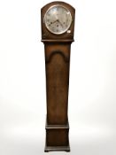 A 1930s oak granddaughter clock, height 137 cm.