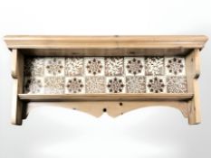 A pine wall shelf with tile inset back, width 70 cm.