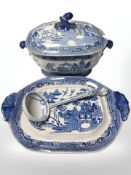 A blue and white transfer printed willow pattern soup tureen with ladle, on stand, width 40 cm.