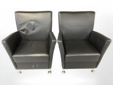 A pair of Danish stitched black leather armchairs