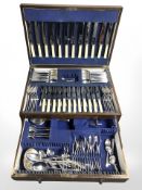 An Edwardian canteen on stand containing a service of EPNS and stainless steel cutlery, width 58 cm.