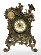 An Art Nouveau gilt metal and velvet cased mantel timepiece with enameled dial, height 19.5 cm.