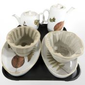 Two earthenware jelly moulds and four pieces of Royal Worcester oven to table wares.