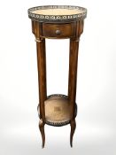 A 20th century mahogany plant stand with brass galleried leather inset top,