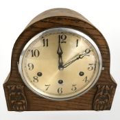 An early 20th century carved oak mantel clock, height 22 cm.