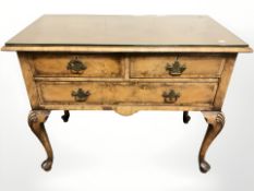 A Waring & Gillow Limited walnut three low boy in the George II style, fitted three drawers,