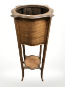 An Edwardian inlaid mahogany jardiniere stand, height 98 cm.