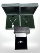 A silver dress ring and two pendants.