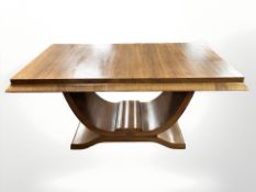 An Art Deco style walnut rectangular dining table on curved support, 157 cm L x 92 cm W x 75 cm H.