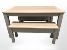 A contemporary oak effect rectangular table, length 135 cm, and two matching benches.