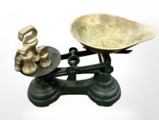 A set of scales with brass pan and weights