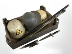 A reproduction swordstick, German dagger and three helmets.