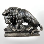 A cast iron lion doorstop, width 28 cm.