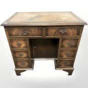 A mahogany twin pedestal knee hole writing desk, fitted eight drawers, 80 cm W x 50 cm D x 76 cm H.
