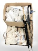 A group of antique lace items, umbrellas, a small vintage luggage case, etc.