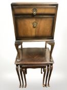 A walnut pot cupboard and a nest of three mahogany tables.