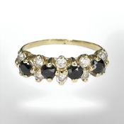 A yellow gold sapphire and ten stone diamond ring, size L/M.