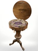 A Victorian figured walnut circular pedestal work table, height 75 cm.