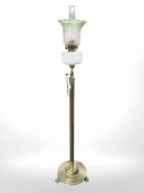 A late 19th century brass standard oil lamp on lion paw feet,