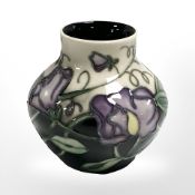 A modern Moorcroft bulbous vase, dated 2003, height 8 cm.