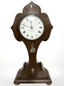 A mahogany and mother of pearl inlaid Art Nouveau mantel clock retailed by Goldsmiths, Newcastle,