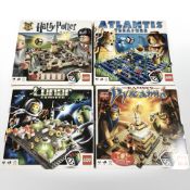 Four boxed LEGO sets comprising Harry Potter, Atlantis Treasure, Lunar Command and Ramses Pyramid.