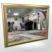 A contemporary bevelled mirror in a gilded frame, 117 cm x 91 cm.