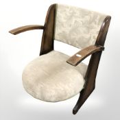 A 1920s oak framed low chair, width 50 cm.