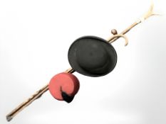 Three rustic wooden walking sticks, a fez and a Belson bowler hat retailed by Bell & Sons,