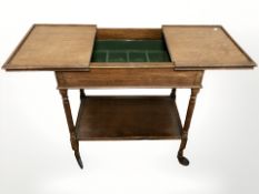 An Edwardian oak serving trolley,