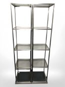 A pair of contemporary brushed metal and glass open shelves,