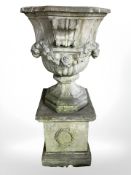 An impressive Victorian weathered octagonal classical urn, probably Coade stone,
