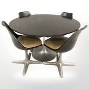 A black ash circular dining table and four chairs, designed by Morris Burk,