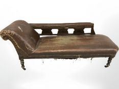 A Victorian distressed faux leather chaise longue,