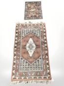 An Iranian rug on salmon ground, 148 cm x 81 cm,