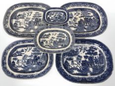 A group of graduated blue and white transfer printed willow pattern meat plates, largest 37 cm wide.
