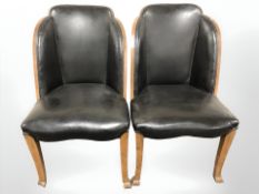 A pair of Art Deco walnut and leather chairs