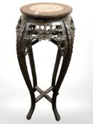 A 19th century Chinese carved hardwood and marble inset jardiniere stand, height 91 cm.