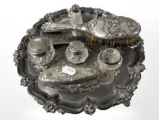 An EPNS salver containing silver mounted dressing table brush, jars, bottles, etc.