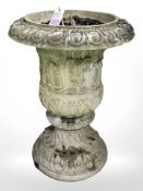 A weathered concrete garden urn,